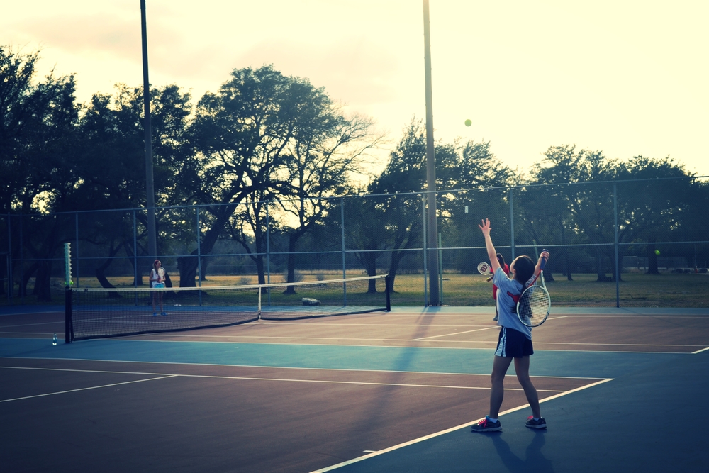 8th grader Amy N. serves to the other team. Photo by Emily