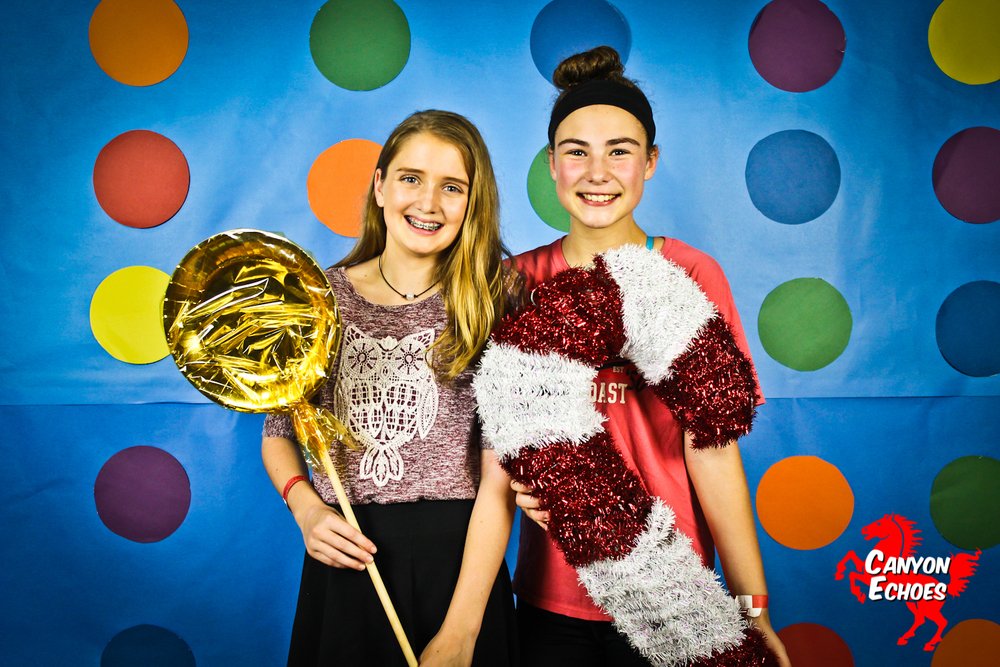 7th Graders Madeleine Shrull and Delaney Willing pose with candy land themed props. Photo By Kara Wilkinson