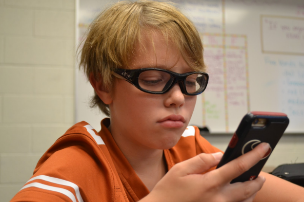 7th grade student spencer miller enjoys the outsiders by s.e. hinton. photo by zack catuogno