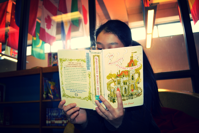 Grace recommends reading “The Mysterious Benedict Society.” Photo by Michelle Koh.