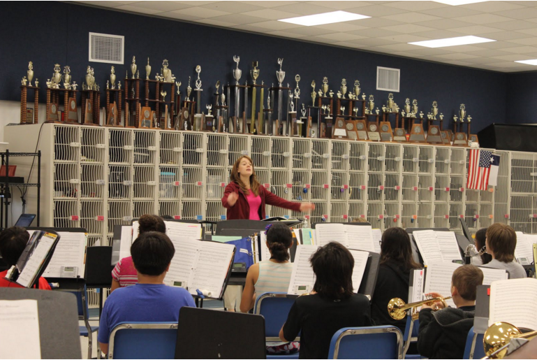 Mrs. Finnigan conducting the Symphonic Band and getting them ready for their next performance. Photo by Rohan Gupta.