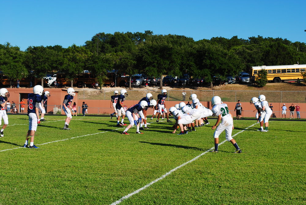 The 7th grade blue team offense gets ready to run a play. Photo by Arjun Seth