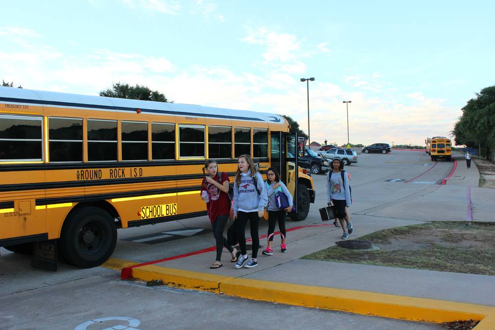 Students exit their buses on a bright morning. Photo by Maggie Findell