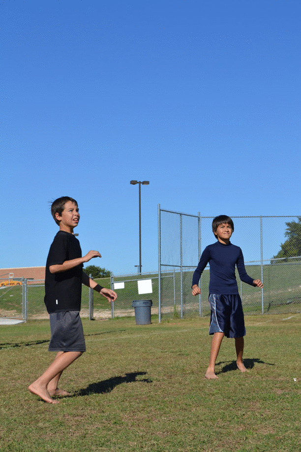 Sixth graders Milo S. and Harris Q. compete for the frisbee at Ultimate Frisbee Club. Photos by Kara Wilkinson