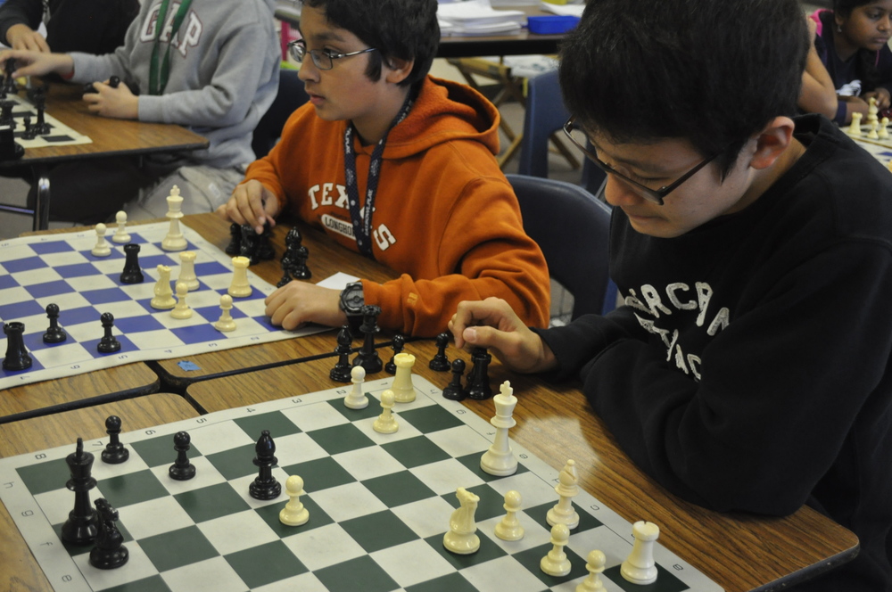 6th grader Aditya D. and 7th grader David K. strategize on their next move at Competitive Chess Club. Photo by Yoonsoo