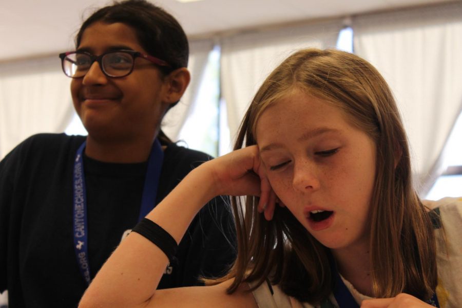 Hannah McDonough is sleepy during class but the girl next to her ( Mehak Mehmi) is exited for class.