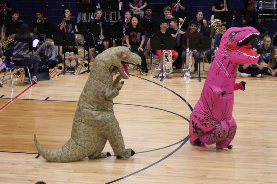 Mrs. Hagerty and Mrs. Gutierrez dance at the pep rally as dinosaurs. 