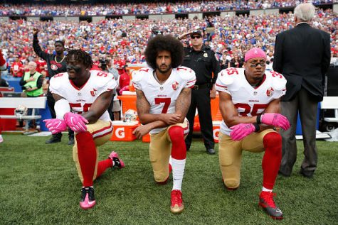 ORCHARD PARK, NY - OCTOBER 15: Eli Harold #58, Colin Kaepernick #7 and Eric Reid #35 of the San Francisco 49ers kneel in protest on the sideline, during the anthem,  prior to the game against the Buffalo Bills at New Era Field on October 16, 2016 in Orchard Park, New York. The Bills defeated the 49ers 45-16. (Photo by Michael Zagaris/San Francisco 49ers/Getty Images)