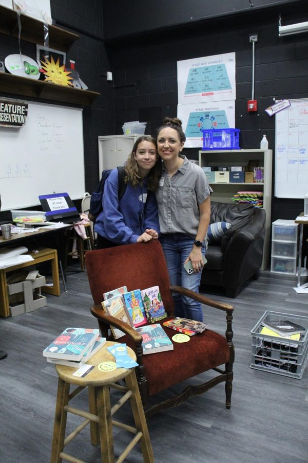 (Left to right) Aurora Simmons with Elizabeth Simmons, in front of the LGBTQIA+ books donated.