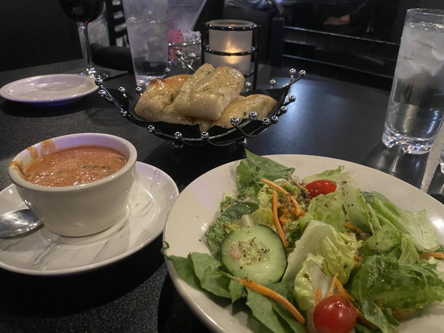 Garden salad with no onions with Italian dressing, tomato basil soup, and breadsticks.