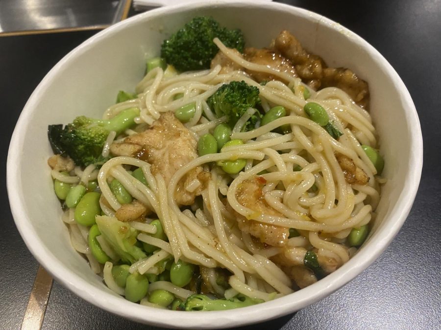 Custom stirfry with chicken, edamame, broccoli, and a lemongrass basil sauce over ramen lomein noodles.