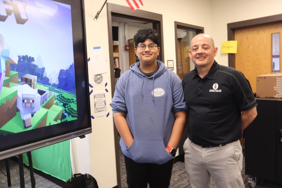 Mr. Ed Acosta and Rithwik Nair (7) standing in front of Minecraft.